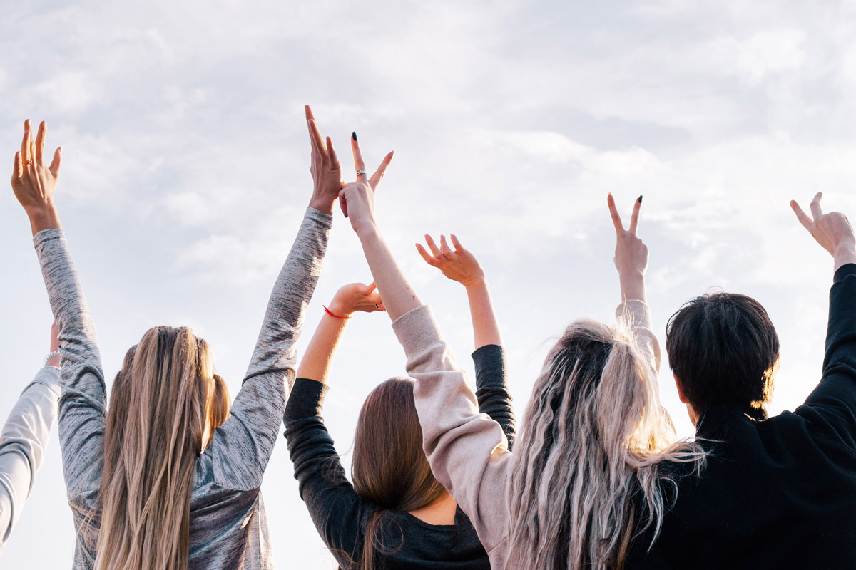 Group with hands in air celebrating free time
