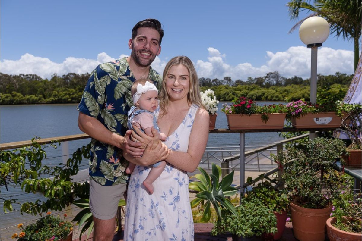 Alexandra with her partner and child on a sunny holiday.