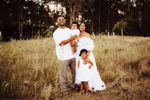 Ziad with his wife and two children standing in a field